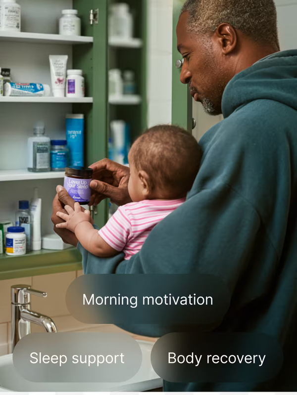 Man holding a baby in a bathroom with shelves of bottles and products.